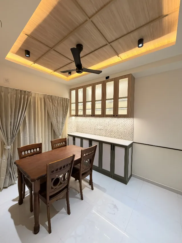 Dining area with layered ceiling lighting completed by Trifold, Chennai