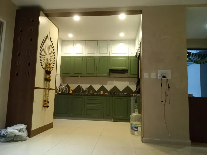 Green modular kitchen framed by timber completed by Trifold, Chennai