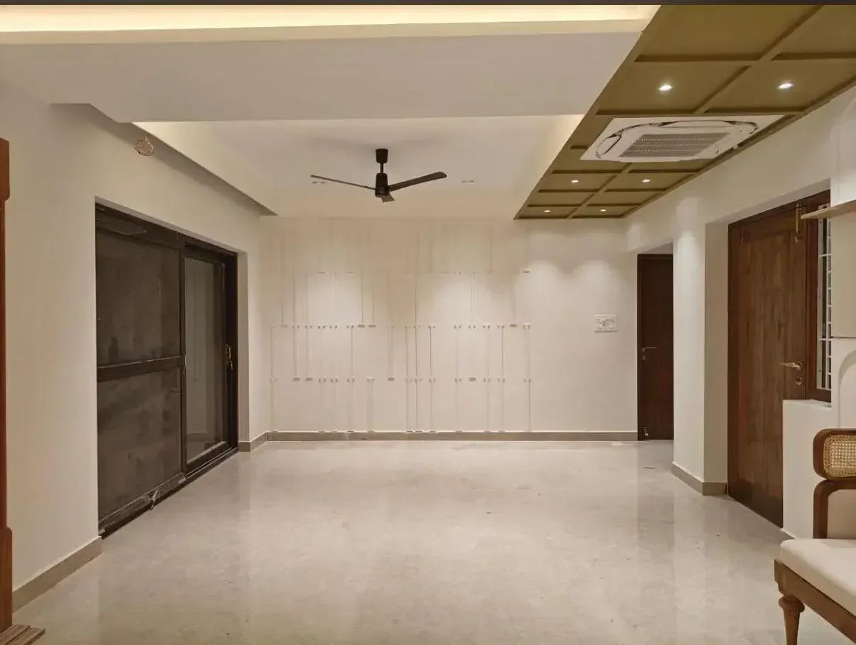 Minimal living space with layered ceiling completed by Trifold, Chennai